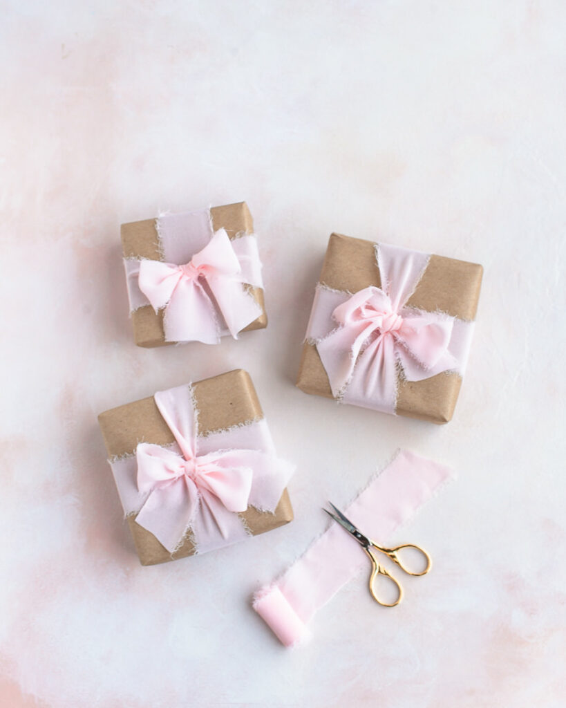 Presents wrapped with recyclable paper and reusable ribbon