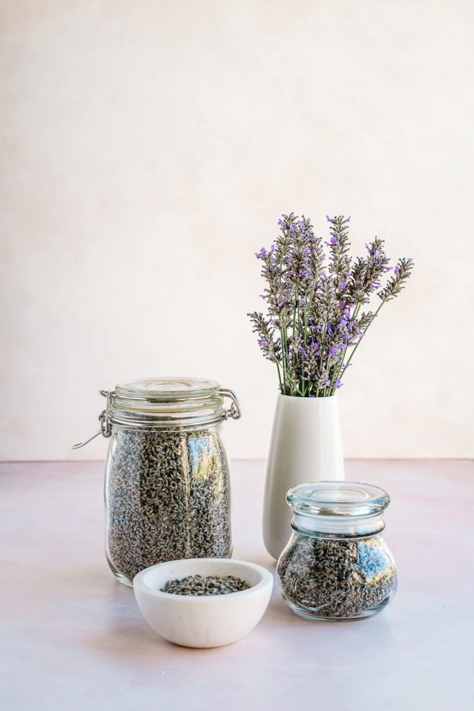 Dried lavender buds stored in jars - How to Harvest and Dry Lavender