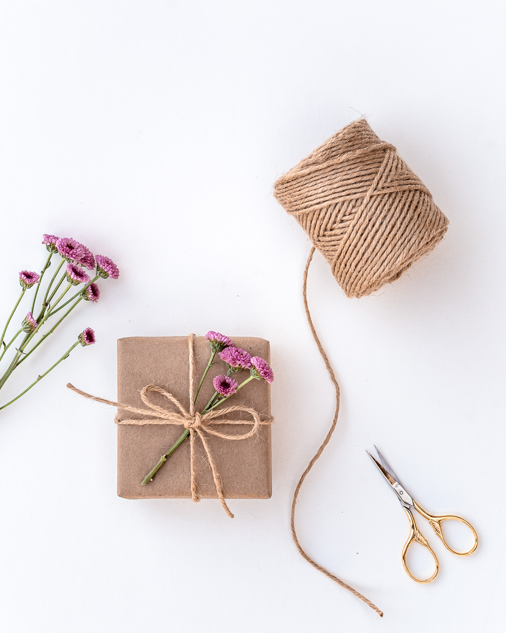 Eco-friendly gift wrapping with twine and flowers