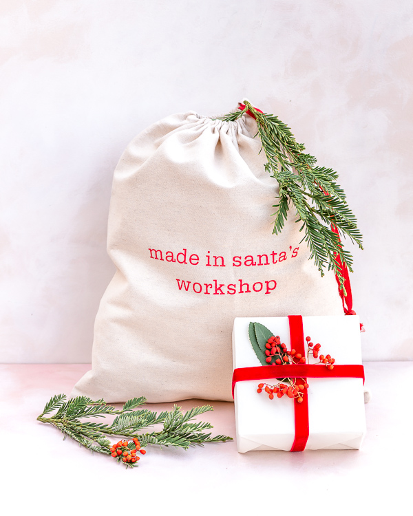 Eco friendly Christmas gift wrapping with recyclable craft paper, reusable Santa bag